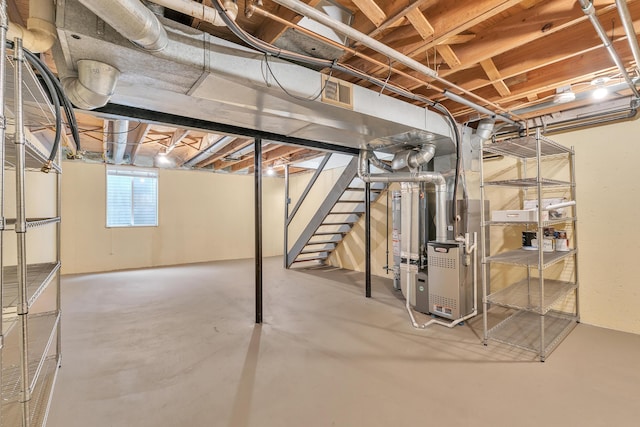 2840 Bombridge Ct, Ann Arbor, MI 48104 - basement with heating unit, stairway, and gas water heater