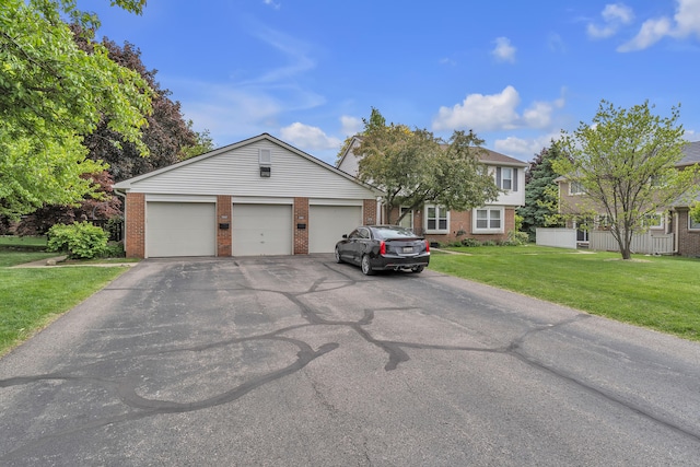 2840 Bombridge Ct, Ann Arbor, MI 48104 - view of front of property with brick siding, a front yard, and asphalt driveway