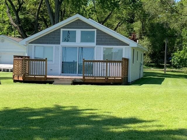 996 Lakeview Dr, Brooklyn, MI 49230 - rear view of house with a deck, a lawn, and view of scattered trees