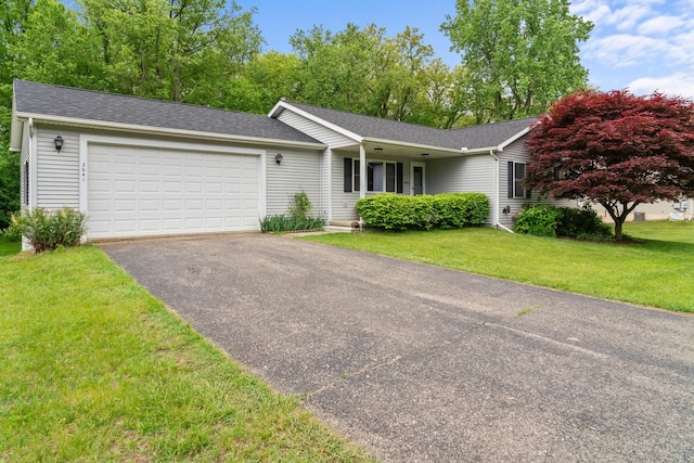 2041 Blackmer Dr, Jonesville, MI 49250 - single story home with an attached garage, driveway, a front yard, and a shingled roof