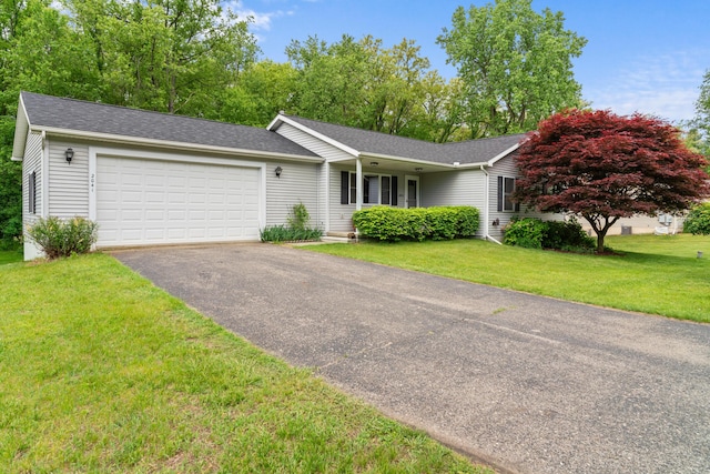 2041 Blackmer Dr, Jonesville, MI 49250 - single story home featuring a garage, asphalt driveway, a front lawn, and roof with shingles
