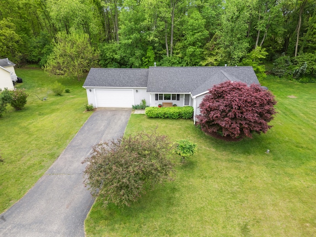 2041 Blackmer Dr, Jonesville, MI 49250 - view of front of home featuring roof with shingles, driveway, a garage, and a front lawn