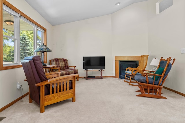 2041 Blackmer Dr, Jonesville, MI 49250 - sitting room featuring carpet flooring, baseboards, vaulted ceiling, and a fireplace with flush hearth