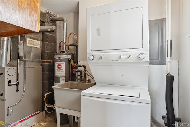 1623 Ethel Ave, Lincoln Park, MI 48146 - laundry room featuring stacked washer / drying machine, heating unit, gas water heater, and electric panel