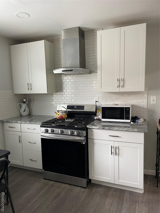 1808 Henbert, West Bloomfield, MI 48324 - kitchen featuring wall chimney exhaust hood, stainless steel gas stove, white microwave, and dark wood finished floors