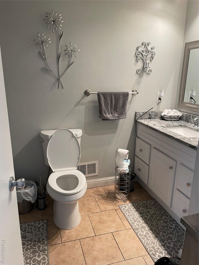 1808 Henbert, West Bloomfield, MI 48324 - bathroom featuring toilet, vanity, tile patterned flooring, and baseboards