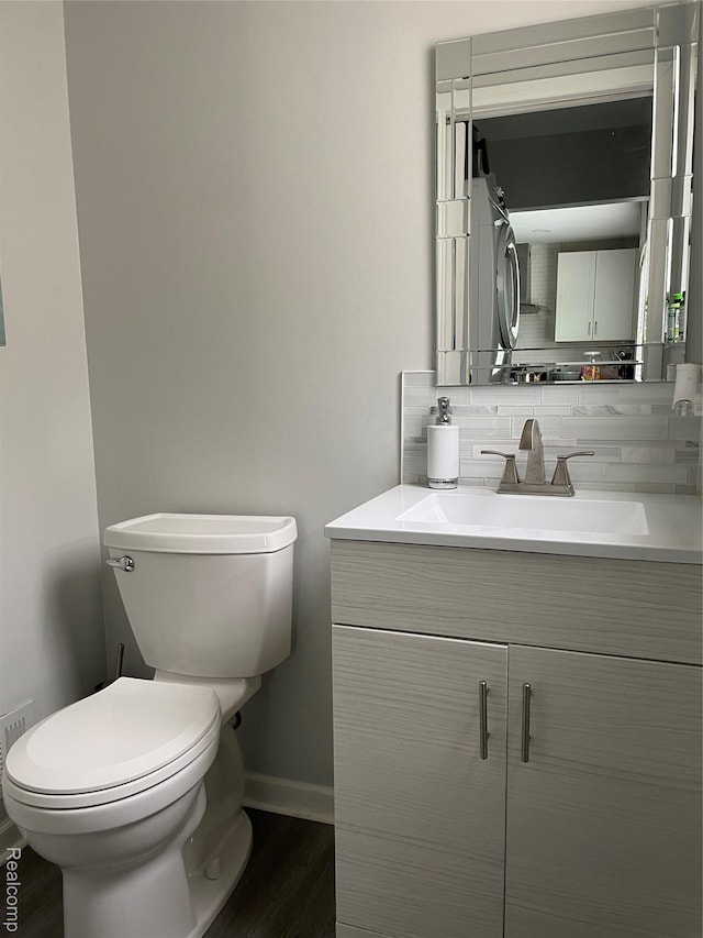 1808 Henbert, West Bloomfield, MI 48324 - bathroom with vanity, wood finished floors, toilet, baseboards, and backsplash
