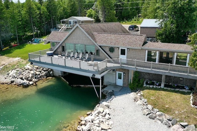 1422 Sims St, De Tour Village, MI 49725 - back of property featuring a deck with water view and roof with shingles