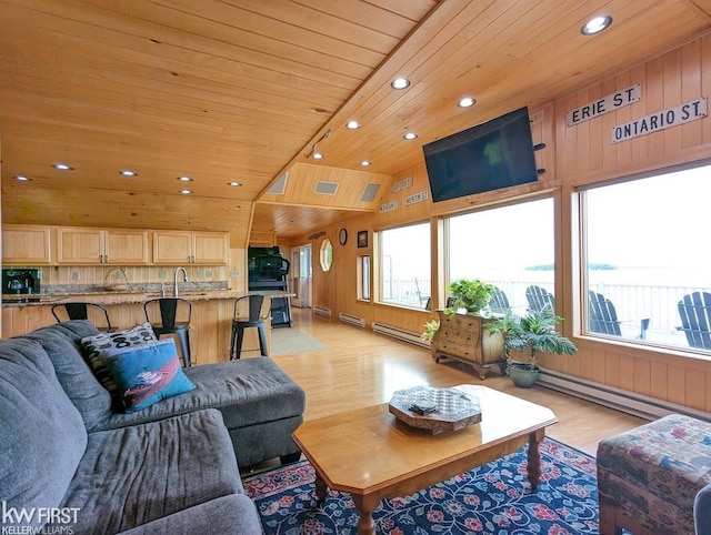 1422 Sims St, De Tour Village, MI 49725 - living area with a baseboard radiator, recessed lighting, light wood finished floors, wood ceiling, and lofted ceiling