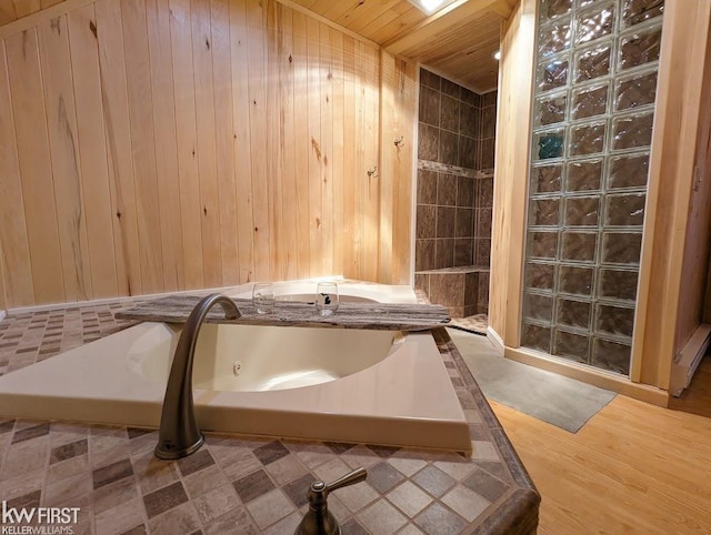 1422 Sims St, De Tour Village, MI 49725 - bathroom with a jetted tub, a tile shower, wood walls, and wood ceiling