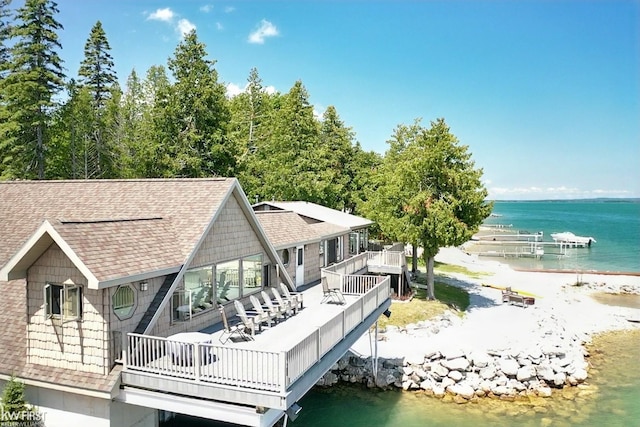 1422 Sims St, De Tour Village, MI 49725 - rear view of house with a shingled roof and a water view