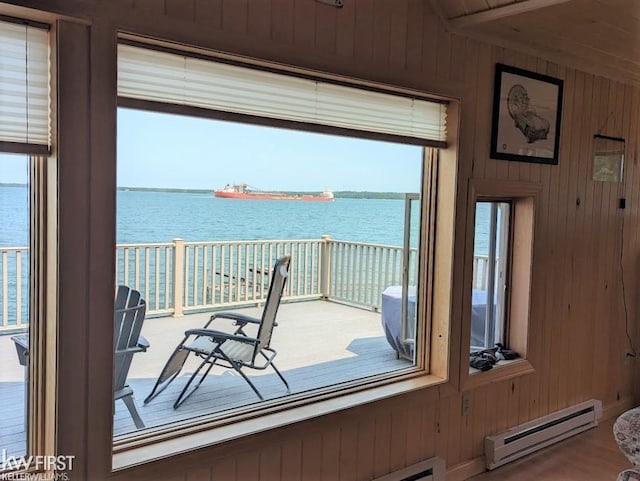 1422 Sims St, De Tour Village, MI 49725 - interior space with a baseboard radiator, a water view, and wood walls