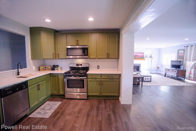 2575 Walnut Rd, Auburn Hills, MI 48326 - kitchen with green cabinets, appliances with stainless steel finishes, a sink, light countertops, and recessed lighting