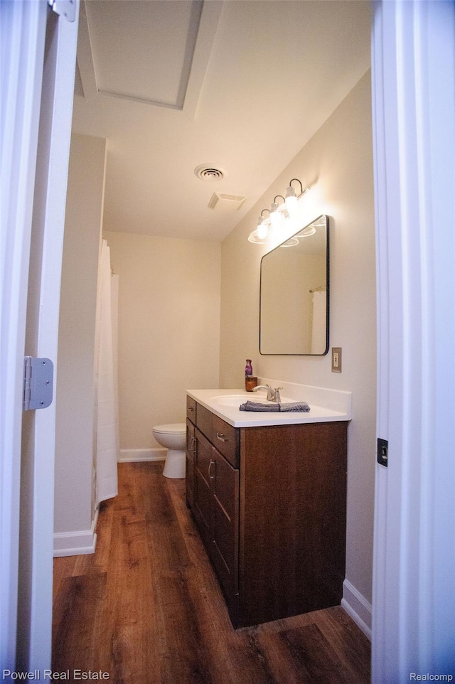 2575 Walnut Rd, Auburn Hills, MI 48326 - bathroom with vanity, wood finished floors, toilet, and baseboards