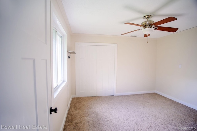 2575 Walnut Rd, Auburn Hills, MI 48326 - unfurnished bedroom featuring carpet floors, a closet, baseboards, and a ceiling fan