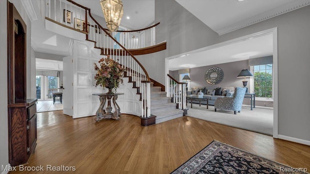 404 Shellbourne Dr, Rochester Hills, MI 48309 - foyer with wood finished floors, stairs, a towering ceiling, ornamental molding, and a chandelier