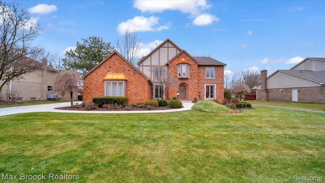 404 Shellbourne Dr, Rochester Hills, MI 48309 - tudor house featuring brick siding and a front lawn