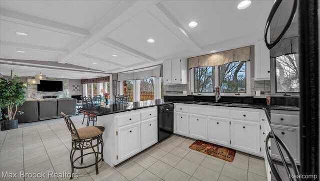 404 Shellbourne Dr, Rochester Hills, MI 48309 - kitchen featuring black dishwasher, a peninsula, open floor plan, white cabinets, and backsplash