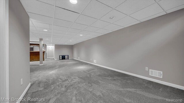 404 Shellbourne Dr, Rochester Hills, MI 48309 - unfurnished living room featuring carpet, a paneled ceiling, baseboards, and recessed lighting