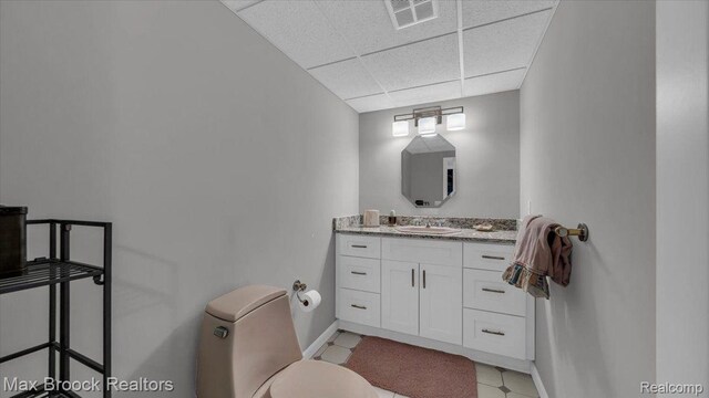 404 Shellbourne Dr, Rochester Hills, MI 48309 - bathroom featuring a paneled ceiling, toilet, vanity, and baseboards