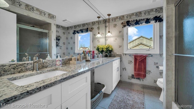 404 Shellbourne Dr, Rochester Hills, MI 48309 - bathroom featuring double vanity, a shower stall, tile patterned floors, toilet, and wallpapered walls