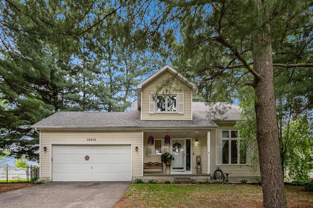 10210 Mizzen Ln, Pleasant Lake, MI 49272 - view of front of home featuring covered porch, driveway, a garage, and a shingled roof