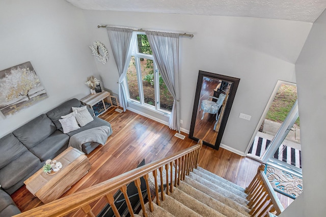 10210 Mizzen Ln, Pleasant Lake, MI 49272 - living room with wood finished floors, baseboards, stairway, and a textured ceiling