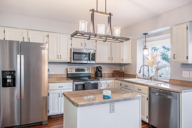 10210 Mizzen Ln, Pleasant Lake, MI 49272 - kitchen with appliances with stainless steel finishes, a sink, white cabinets, a center island, and decorative light fixtures