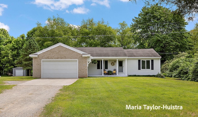 10130 64th Ave, Allendale, MI 49401 - view of front of home with a porch, concrete driveway, a garage, a front yard, and brick siding