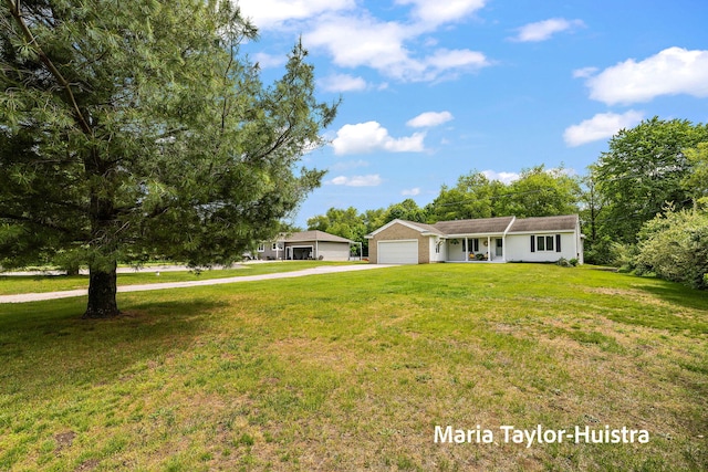 10130 64th Ave, Allendale, MI 49401 - single story home with an attached garage, driveway, and a front lawn