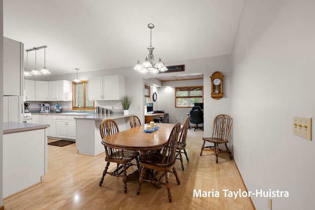10130 64th Ave, Allendale, MI 49401 - dining room with light wood finished floors, a chandelier, and a desk