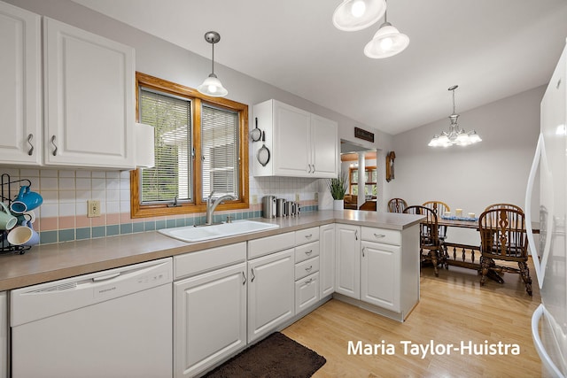 10130 64th Ave, Allendale, MI 49401 - kitchen featuring white appliances, a sink, healthy amount of natural light, white cabinetry, and lofted ceiling