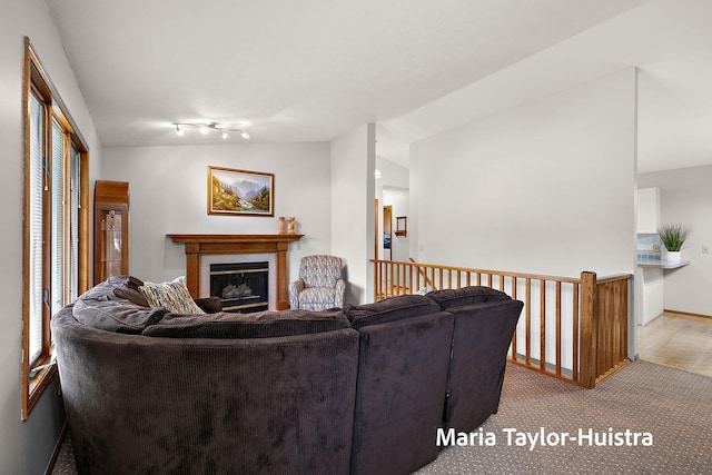 10130 64th Ave, Allendale, MI 49401 - carpeted living area with a tile fireplace, lofted ceiling, and baseboards