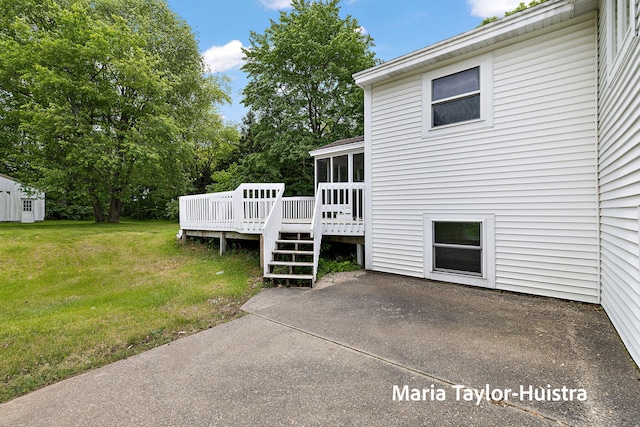 10130 64th Ave, Allendale, MI 49401 - back of house featuring a sunroom, a lawn, a wooden deck, and a patio
