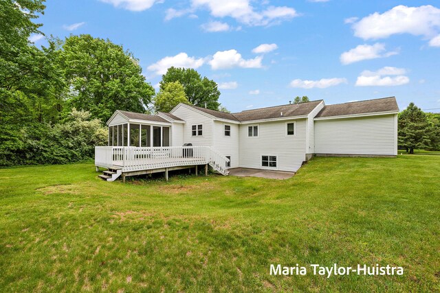 10130 64th Ave, Allendale, MI 49401 - back of house featuring a sunroom, a patio area, a lawn, and a deck