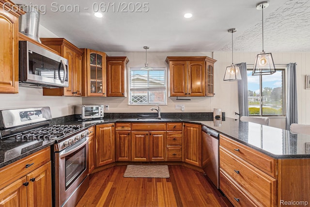 687 Sunnybeach Dr, White Lake, MI 48386 - kitchen with stainless steel appliances, brown cabinets, dark wood-style floors, and recessed lighting