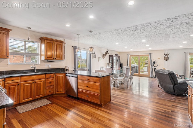 687 Sunnybeach Dr, White Lake, MI 48386 - kitchen with stainless steel dishwasher, open floor plan, a sink, brown cabinets, and recessed lighting