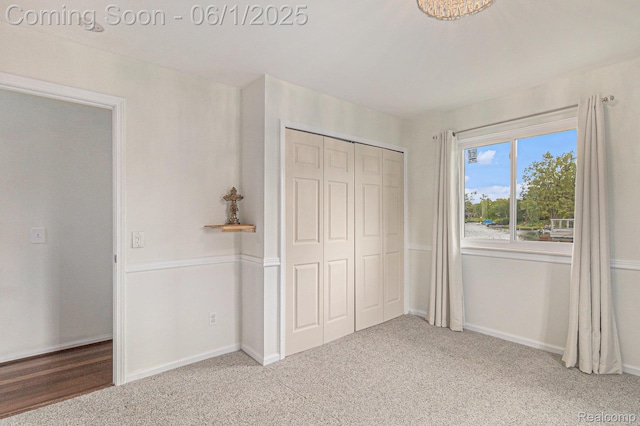687 Sunnybeach Dr, White Lake, MI 48386 - unfurnished bedroom featuring a closet, carpet flooring, and baseboards