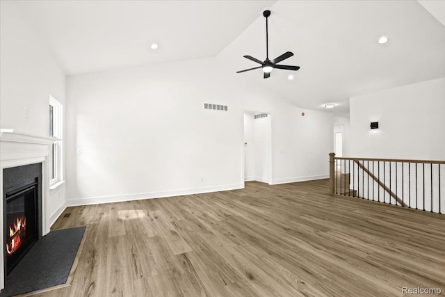 11308 Merriman Rd, Livonia, MI 48150 - unfurnished living room featuring a glass covered fireplace, ceiling fan, wood finished floors, recessed lighting, and baseboards