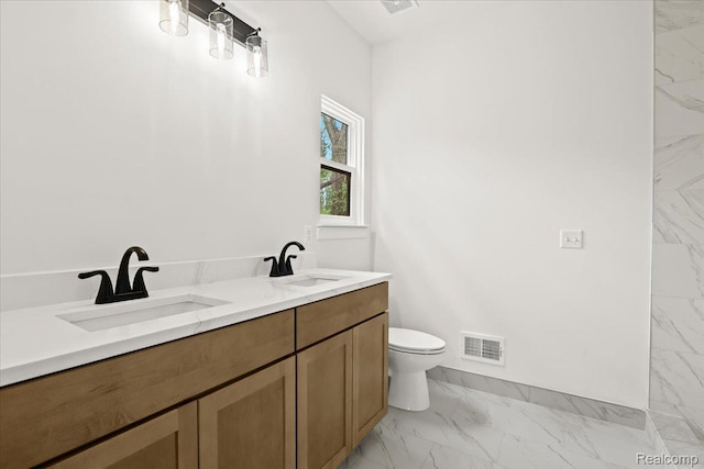 11308 Merriman Rd, Livonia, MI 48150 - full bath with marble look tiles, toilet, double vanity, and baseboards