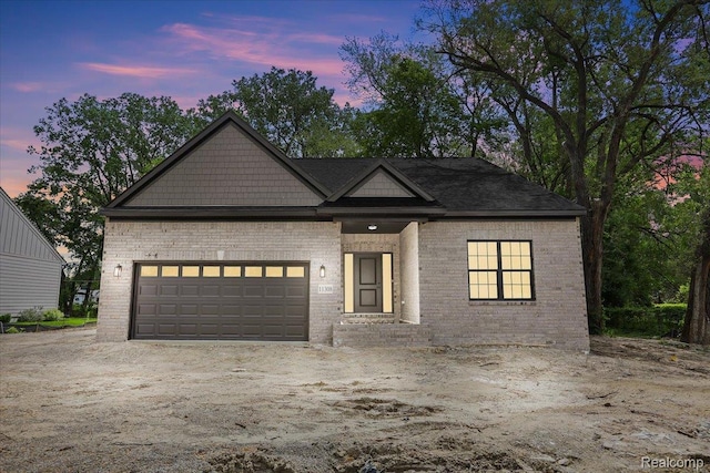 11308 Merriman Rd, Livonia, MI 48150 - view of front of house featuring brick siding, a garage, and driveway