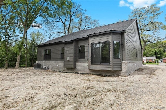 11308 Merriman Rd, Livonia, MI 48150 - view of front of house with central AC unit, brick siding, and roof with shingles
