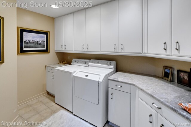 401 Glazier Rd, Chelsea, MI 48118 - washroom featuring cabinet space, washer and clothes dryer, and baseboards