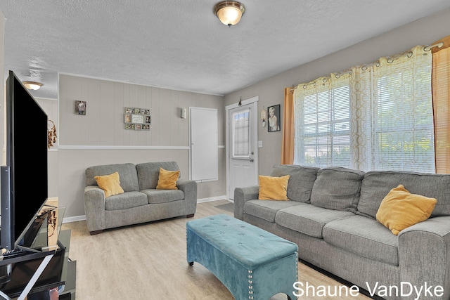 88 Violet St SW, Grand Rapids, MI 49548 - living room featuring a textured ceiling, wood finished floors, and baseboards
