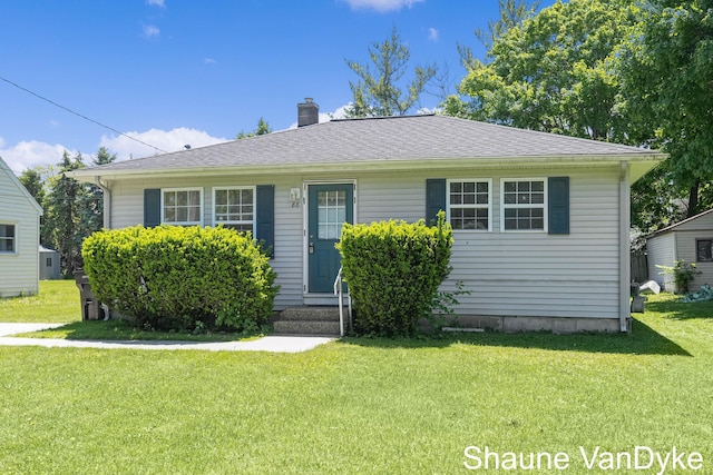 88 Violet St SW, Grand Rapids, MI 49548 - bungalow featuring entry steps, a front lawn, and a chimney