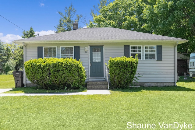 88 Violet St SW, Grand Rapids, MI 49548 - view of front of property featuring a chimney and a front lawn