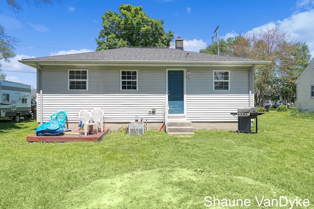 88 Violet St SW, Grand Rapids, MI 49548 - rear view of property featuring a yard, a chimney, entry steps, and a shingled roof