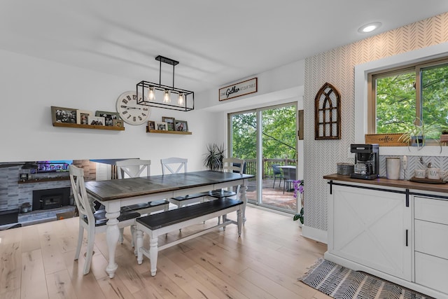 9275 M-50, Onsted, MI 49265 - dining space featuring healthy amount of natural light, wallpapered walls, light wood-style flooring, and baseboards