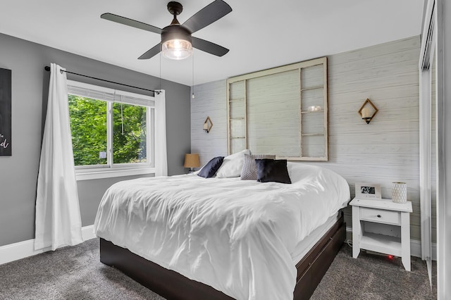 9275 M-50, Onsted, MI 49265 - bedroom with wooden walls, dark carpet, a ceiling fan, and baseboards