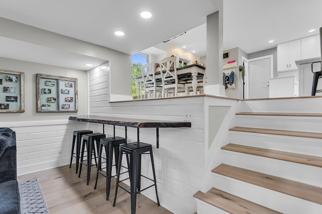 9275 M-50, Onsted, MI 49265 - bar area with wood finished floors, recessed lighting, wood walls, and stairway